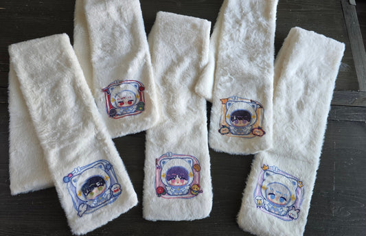 Set of white scarfs with printed designs of sylus, rafayel, caleb, zayne and xavier on a wooden surface